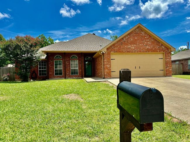 View of front facade with a garage, driveway, brick siding, and a shingled roof | Image 24