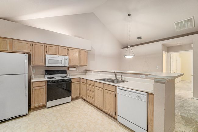 Accent lighting above fur downs. Comes with a dishwasher, garbage disposal, microwave and gas stove. The refrigerator will convey. | Image 7