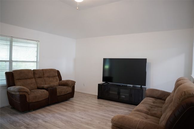 Living area with light wood-type flooring, plenty of natural light, and baseboards | Image 17