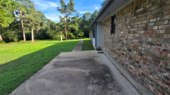 View of grassy yard with a patio area | Image 18
