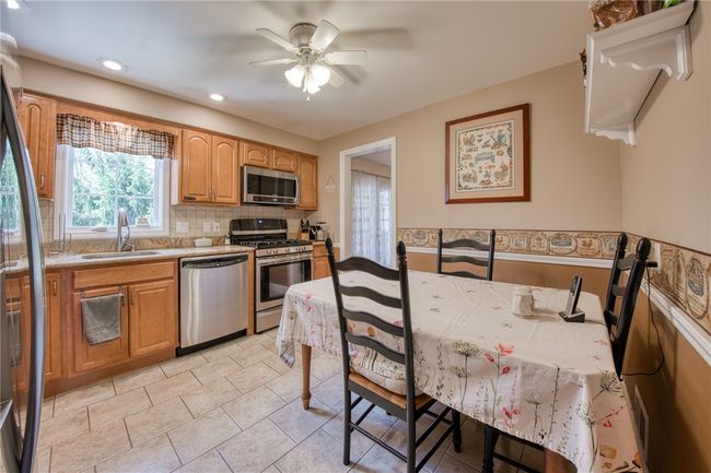 Large eat-in-kitchen with newer stainless steal appliances and granite countertops | Image 14