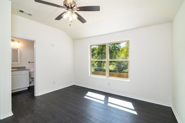 Bedroom featuring connected bathroom, dark hardwood / wood-style floors, vaulted ceiling, and ceiling fan | Image 15