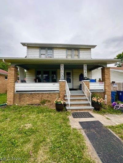 View of front of home featuring a front lawn and a porch | Image 1