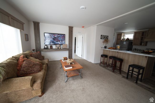 Living area with carpet floors and ornate columns | Image 58