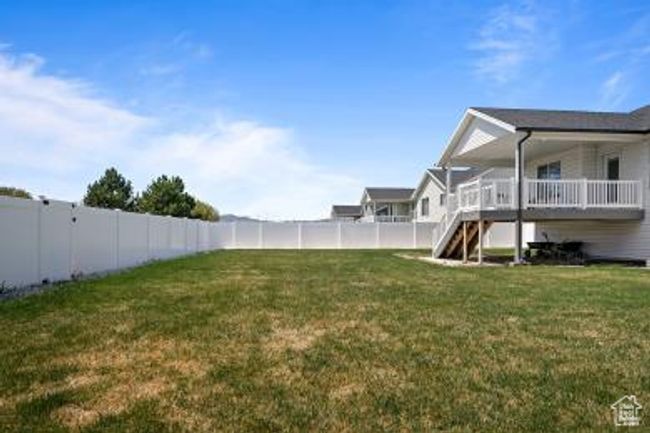 View of yard featuring a fenced backyard and stairs | Image 39