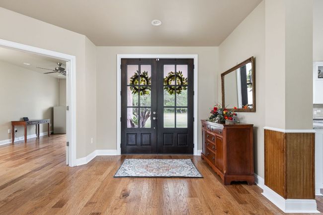 A welcoming double front door sets the tone for this charming farmhouse-style home. | Image 5
