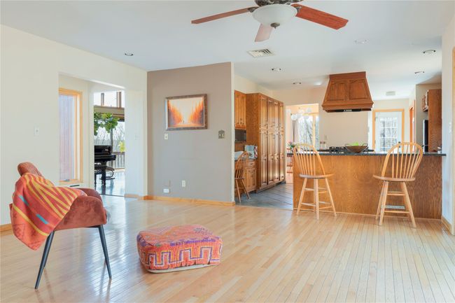 Kitchen featuring light wood-style flooring, visible vents, brown cabinets, and a wealth of natural light | Image 12