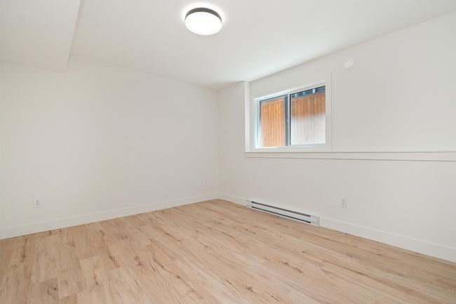 Spare room with baseboard heating and wood finished floors | Image 36