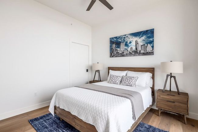 Bedroom featuring wood finished floors, a ceiling fan, and baseboards | Image 10