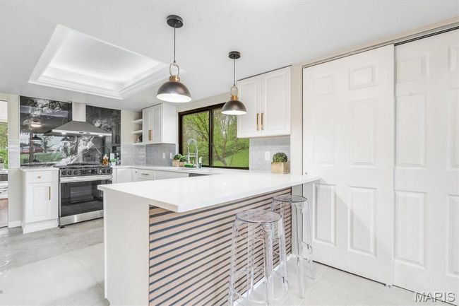 Detailed view of wood finished floors and a decorative wall | Image 13