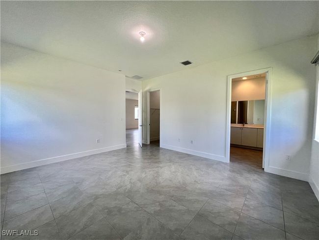 Spare room featuring a textured ceiling | Image 16
