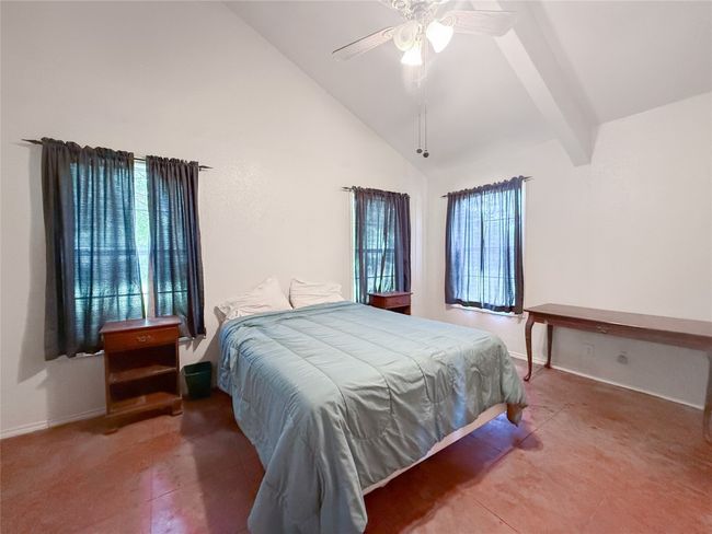 Bedroom with ceiling fan, high vaulted ceiling, beamed ceiling, and baseboards | Image 7