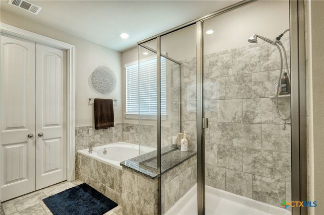 Primary bathroom with walk in shower and tub. | Image 16