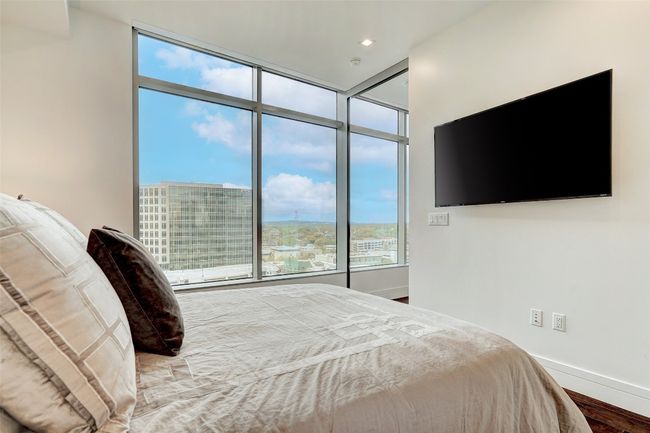 Bedroom featuring multiple windows and wood finished floors | Image 16