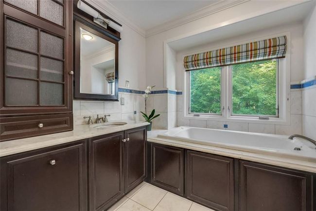 Primary Bathroom with two vanities and a private water closet. | Image 17