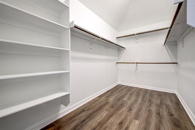 Spacious closet featuring dark wood-style floors | Image 19