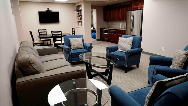 Living room with light colored carpet and bar area | Image 11