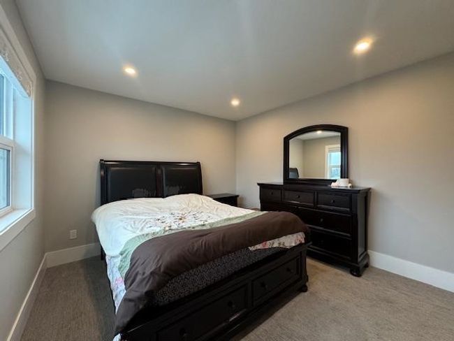 Bedroom with recessed lighting, light colored carpet, and multiple windows | Image 29