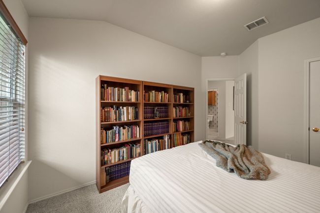 Cozy guest bedroom with neutral tones, plush carpet, and great natural light from the large window. | Image 28