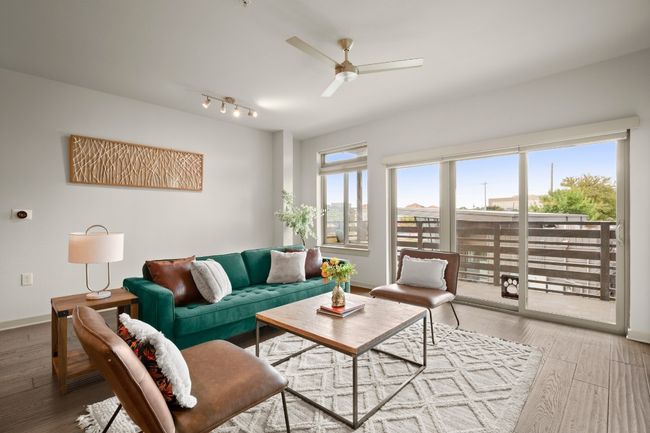 Living room with a ceiling fan, wood finished floors, baseboards, and track lighting | Image 20
