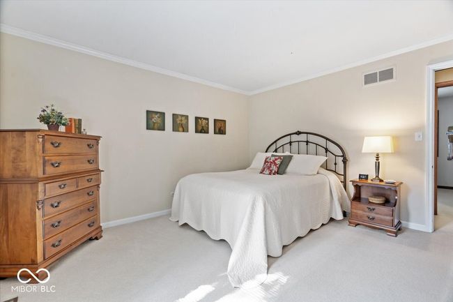 bedroom featuring light carpet and ornamental molding | Image 31
