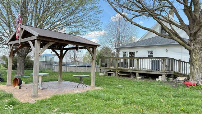 view of yard with a wooden deck, a gazebo, fence, and a patio | Image 8