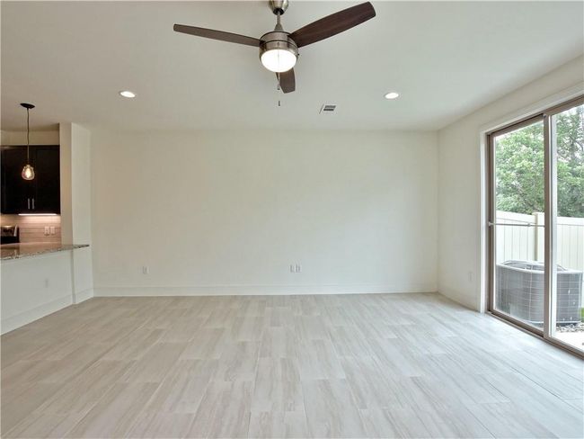Unfurnished living room featuring a ceiling fan, light wood-style floors, and recessed lighting | Image 5