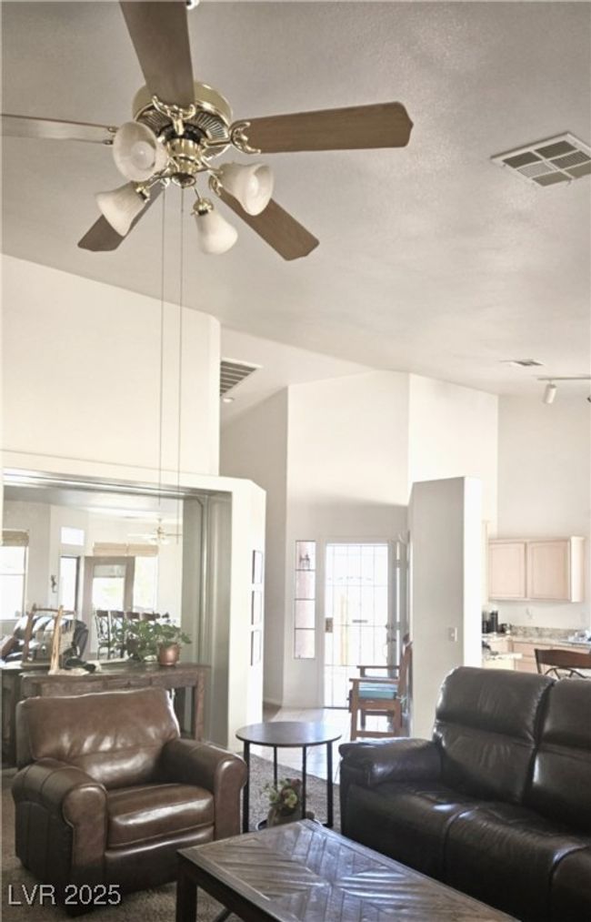 Living room featuring a ceiling fan, plenty of natural light, and a towering ceiling | Image 21