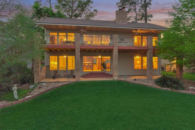 Expansive upper and lower porches run the full length of the home, providing stunning lake views from almost every room. | Image 37