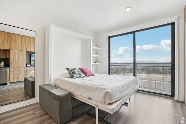 Bedroom with light wood-type flooring, recessed lighting, and access to outside | Image 18