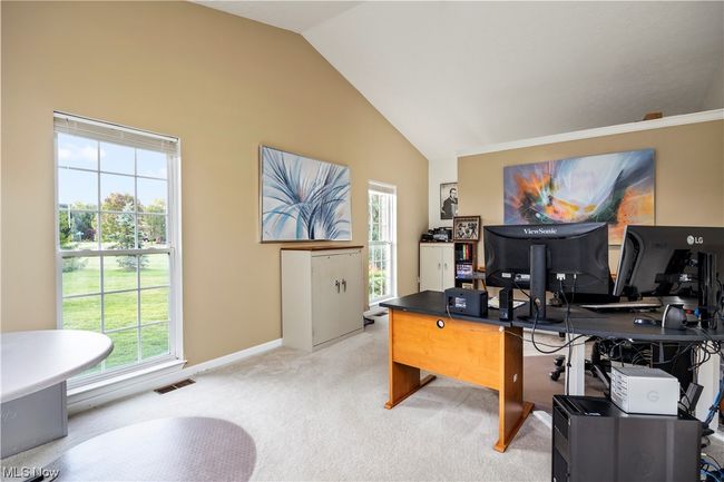 Carpeted office space featuring lofted ceiling | Image 7