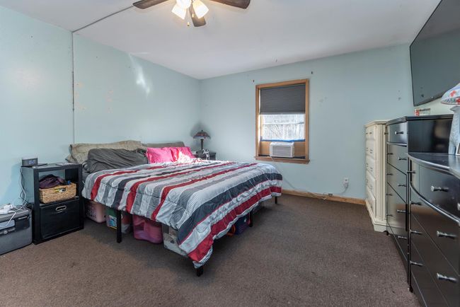 Bedroom featuring carpet floors, ceiling fan, and cooling unit | Image 35