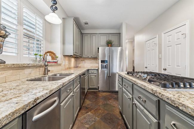 The kitchen features cutting-edge style and design, perfect for modern living. | Image 14