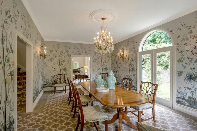 Dining area featuring crown molding, a wealth of natural light, and an inviting chandelier | Image 12