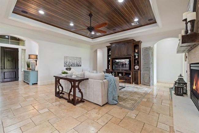The wood paneled ceiling is home to built-in speakers, taking your movie watching to a whole new level. The space is large enough to accommodate a multitude of seating arrangements and can even house additional storage options. | Image 11