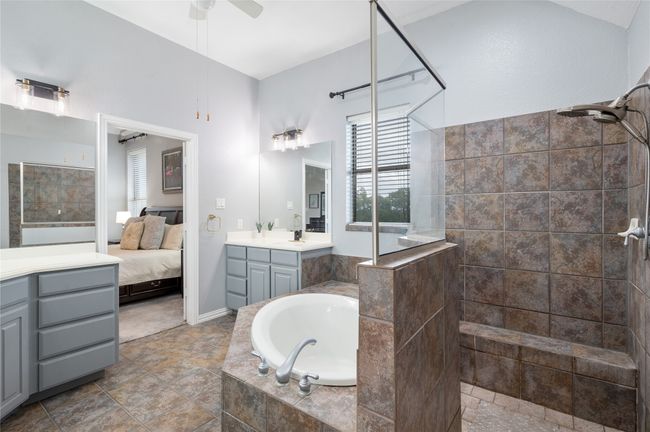 Bathroom with vanity, a walk in shower, a garden tub, a ceiling fan, and ensuite bathroom | Image 25