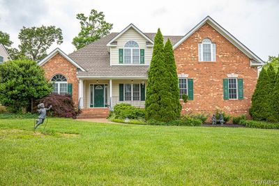 View of property with a front lawn and covered porch | Image 1