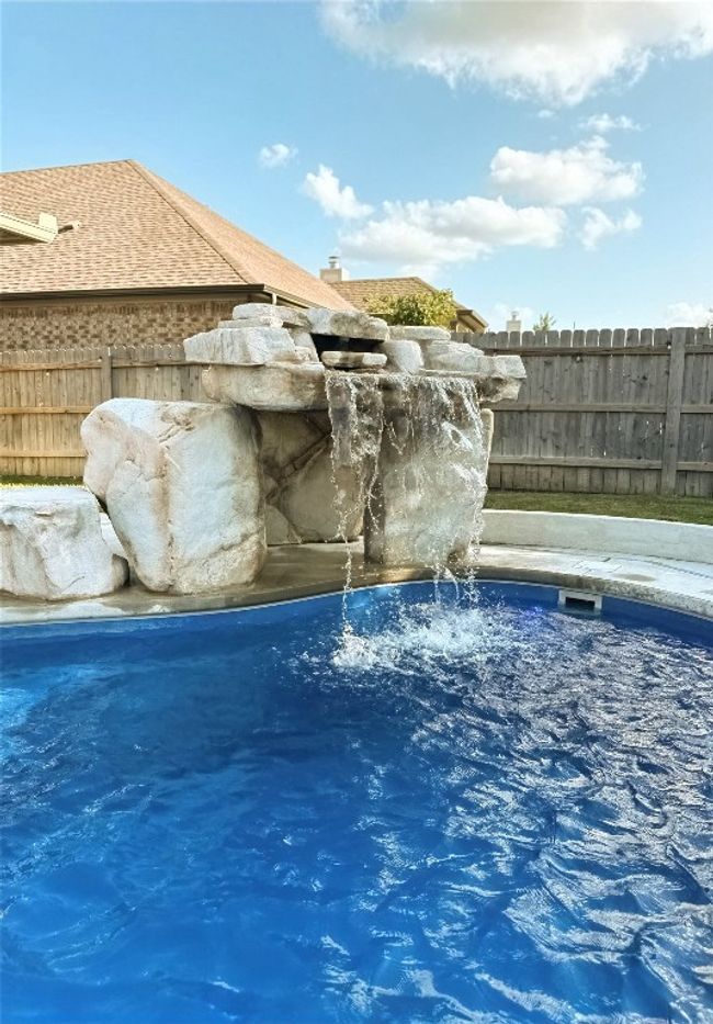 View of pool featuring grotto and waterfall | Image 29