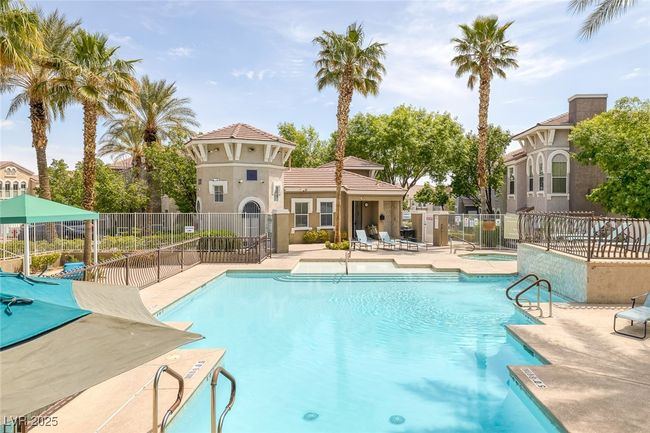 Pool with a patio, a hot tub, and fence | Image 27