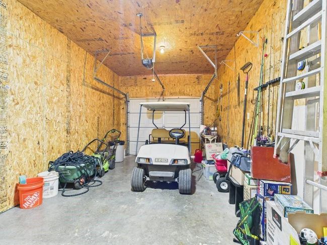 Garage featuring a garage door opener | Image 71