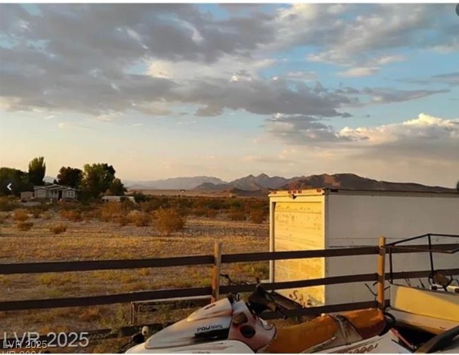 View of yard featuring a mountain view and fence | Image 10