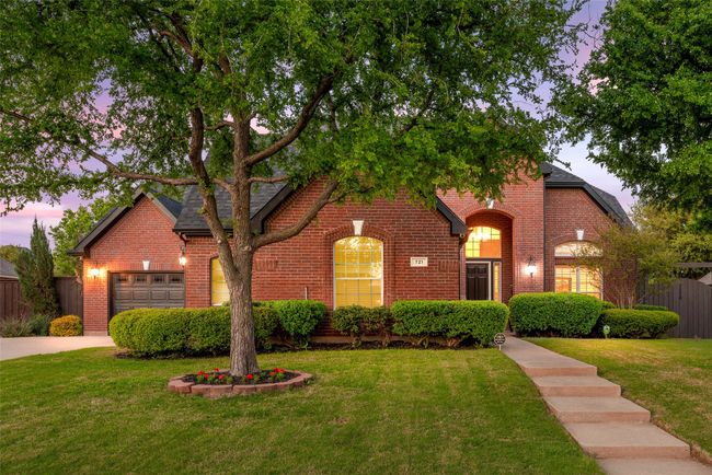 View of front of property featuring a yard, brick siding, and fence | Image 31