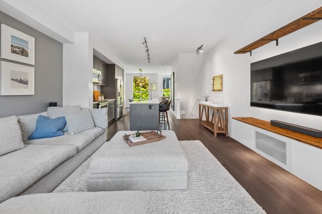Living area with dark wood-style floors and track lighting | Image 6