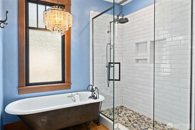 A beautifully tiled shower with a glass door complements the space, while Mason Hill Collection plumbing fixtures throughout the bathroom add a touch of artisan quality and timeless sophistication. | Image 25