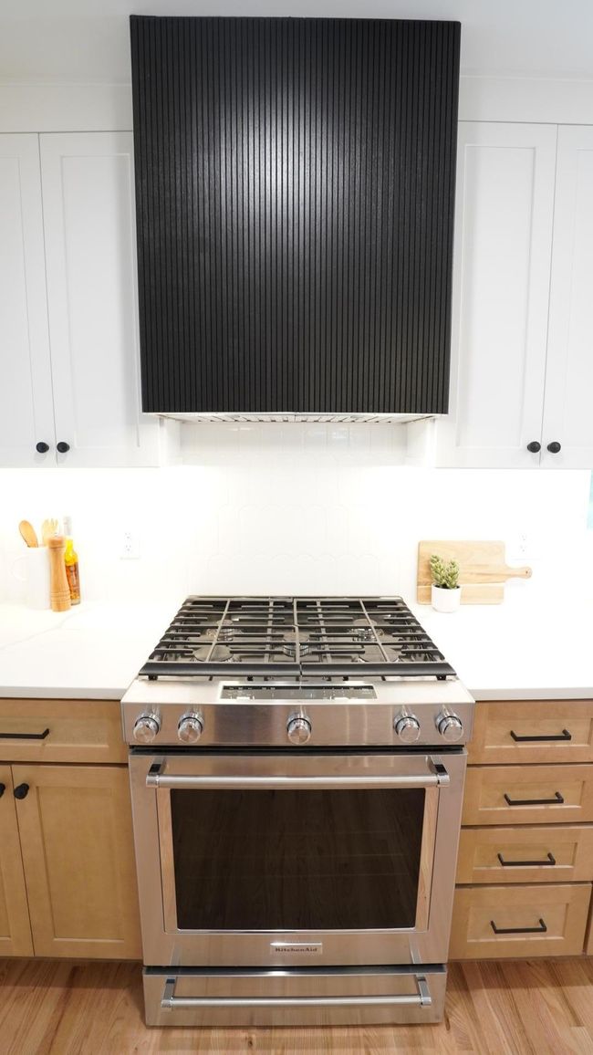 The Kitchenaid gas range features a sleek, custom range hood. | Image 10