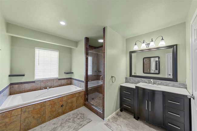 Bathroom with vanity, a shower stall, and a garden tub | Image 24