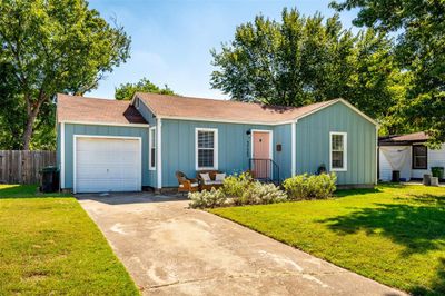 Ranch-style house featuring a front yard and a garage | Image 2