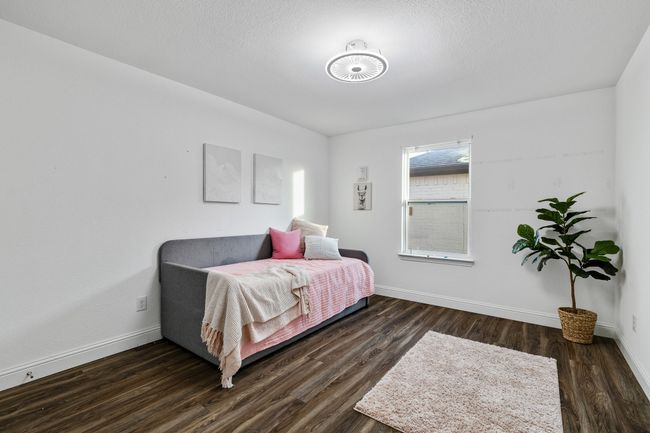 Bedroom featuring dark wood-type flooring and a textured ceiling | Image 19