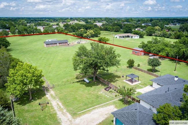 Aerial view of property's location featuring property boundaries highlighted and a tree filled landscape | Image 12
