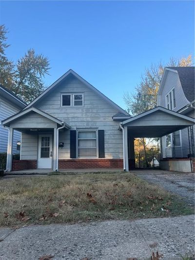 View of front of property featuring covered porch and a carport | Image 1